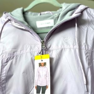 *NWT* Lt weight, lined, hooded CK windbreaker in lilac. Size small.